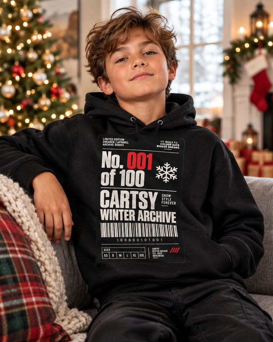 Kid wearing the black Cartsy Winter Archive No. 001 kids hoodie with a sneaker hang-tag graphic