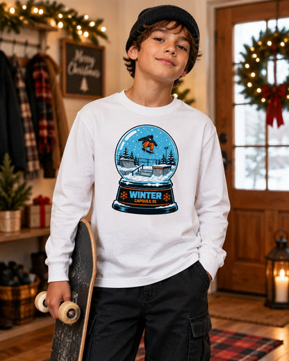 Boy wearing the white Snow Globe Capsule kids long sleeve tee with a snowboarder snow globe graphic