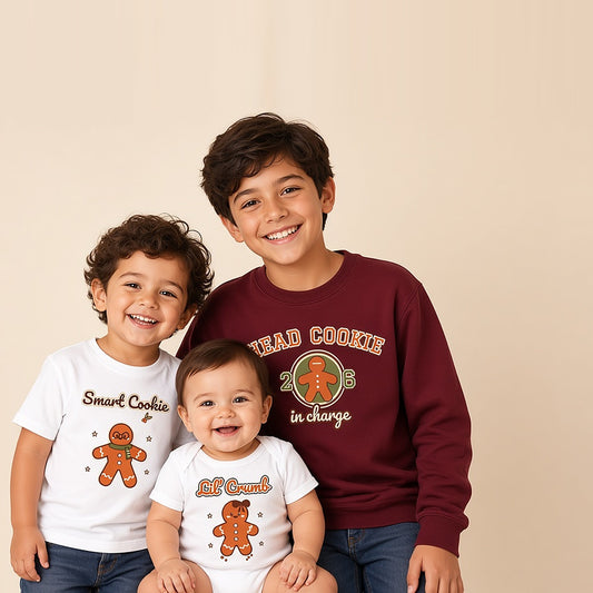 Three siblings in matching Cookie Crew gingerbread Christmas shirts: Head Cookie, Lil' Crumb, and Smart Cookie