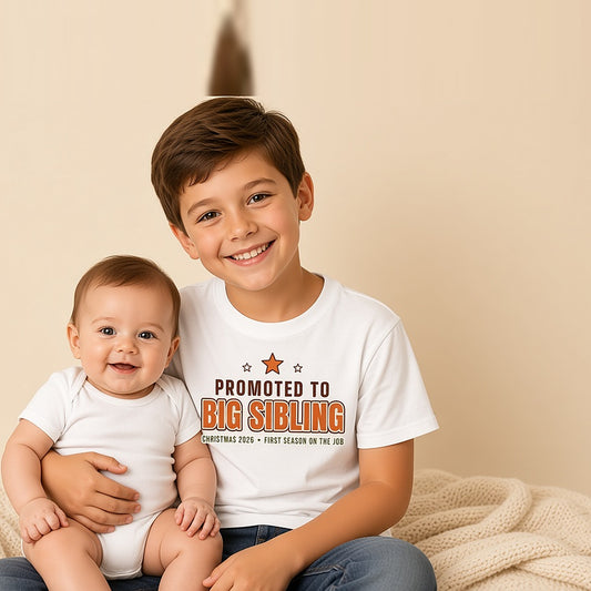 Big brother in the Promoted to Big Sibling tee holding his baby sibling