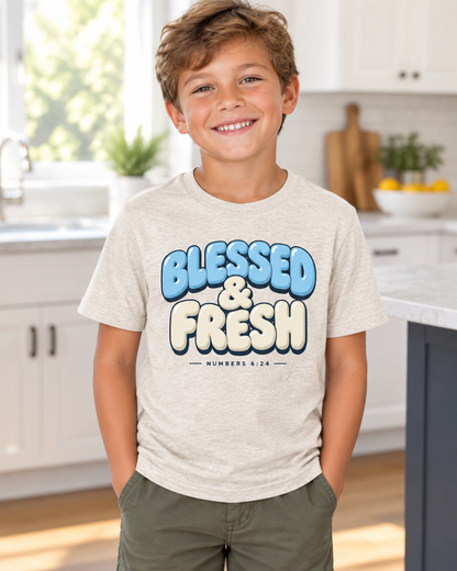 Kid wearing the Cartsy Blessed & Fresh puffy bubble letter Christian tee in heather dust