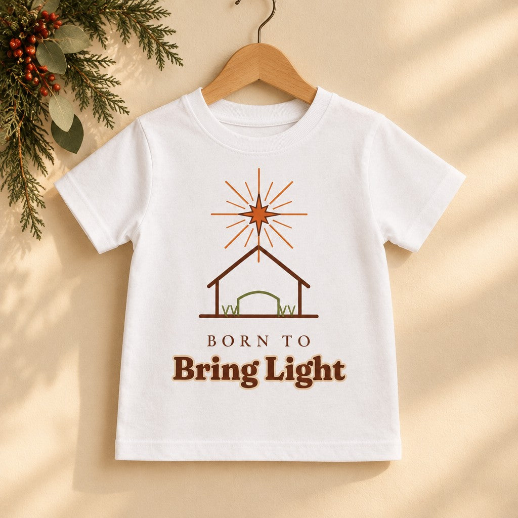 Born to Bring Light Toddler Christmas Shirt: Faith Tee on a wooden hanger