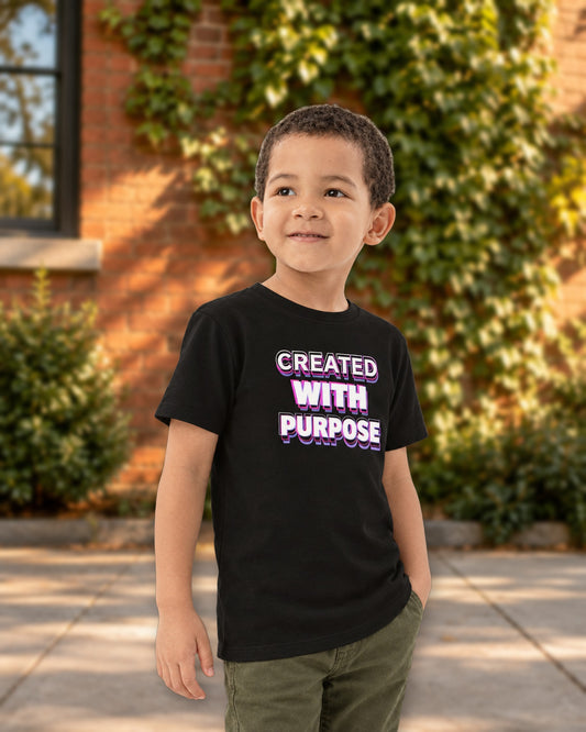 Kid wearing the black Created With Purpose tee on a sunny city street