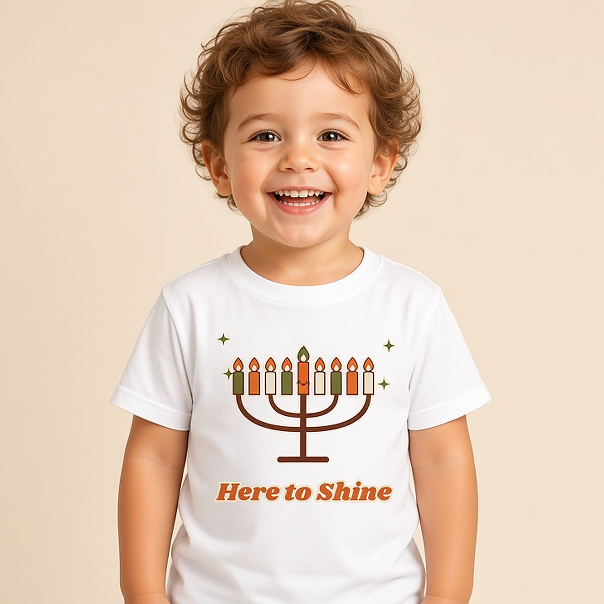 Toddler in the white Here to Shine menorah Hanukkah tee