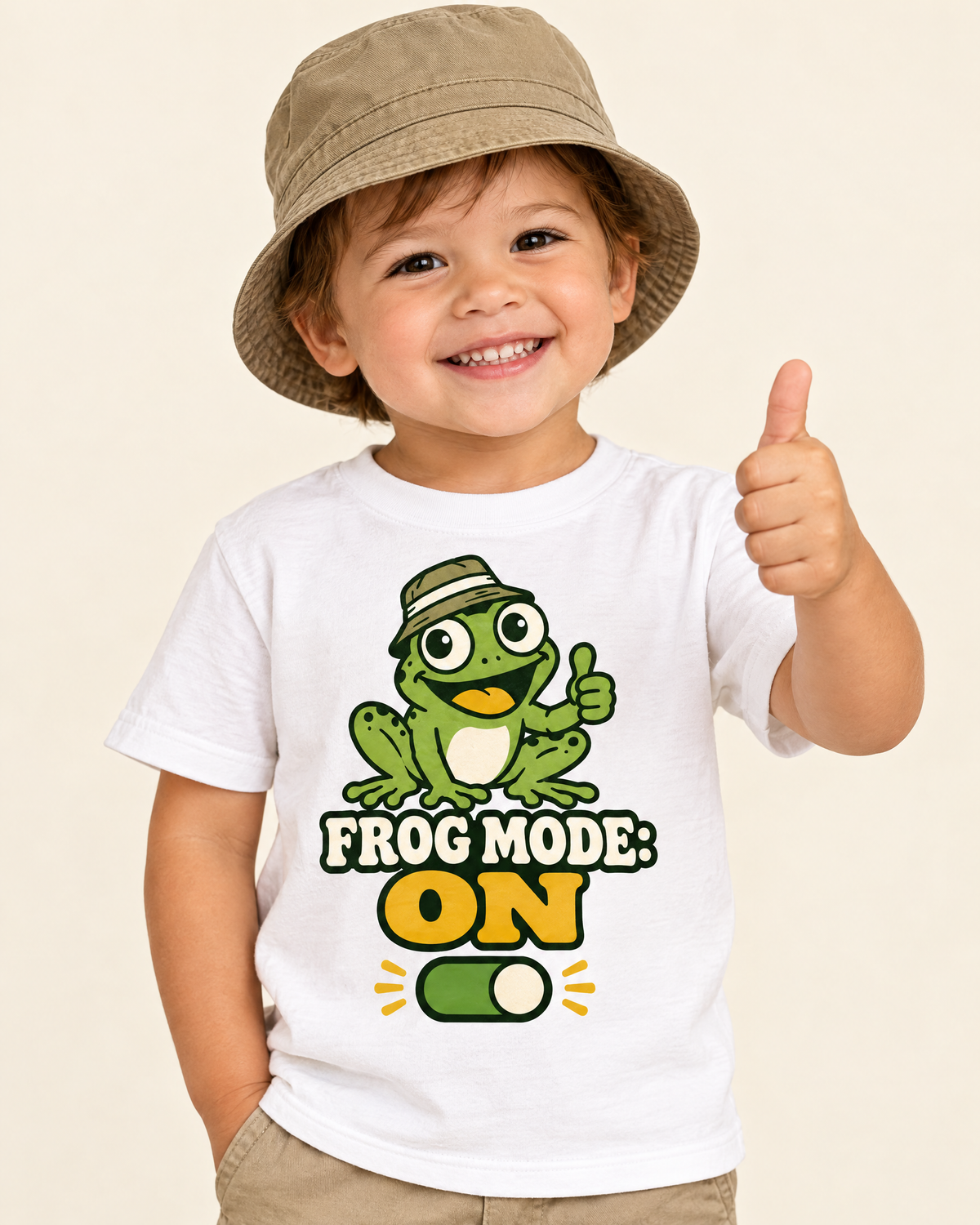 Toddler giving a thumbs up in the Frog Mode ON shirt and bucket hat