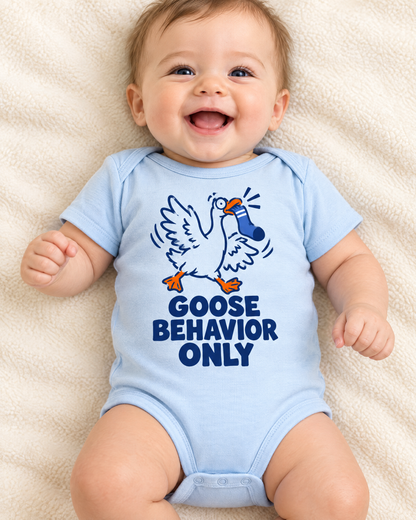 Giggling baby in the light blue Goose Behavior Only bodysuit on a cream blanket