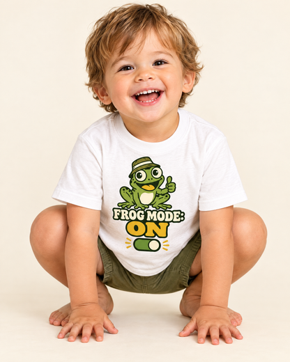 Laughing toddler crouching like a frog in the Frog Mode ON tee