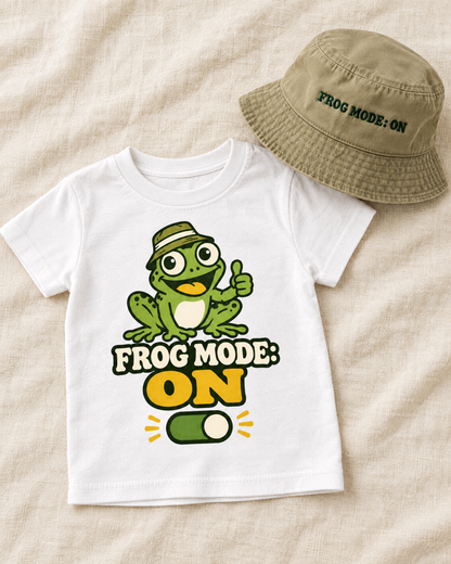 Flat lay of the Frog Mode ON toddler shirt with matching bucket hat