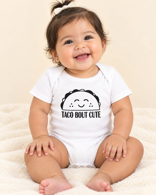 Baby wearing white Taco Bout Cute baby bodysuit, funny taco onesie for infants
