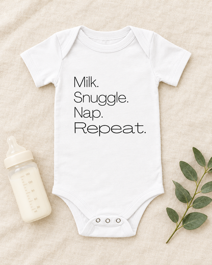 Milk Snuggle Nap Repeat Baby Bodysuit in white, flat lay - cute baby bodysuit gift idea, Cartsy