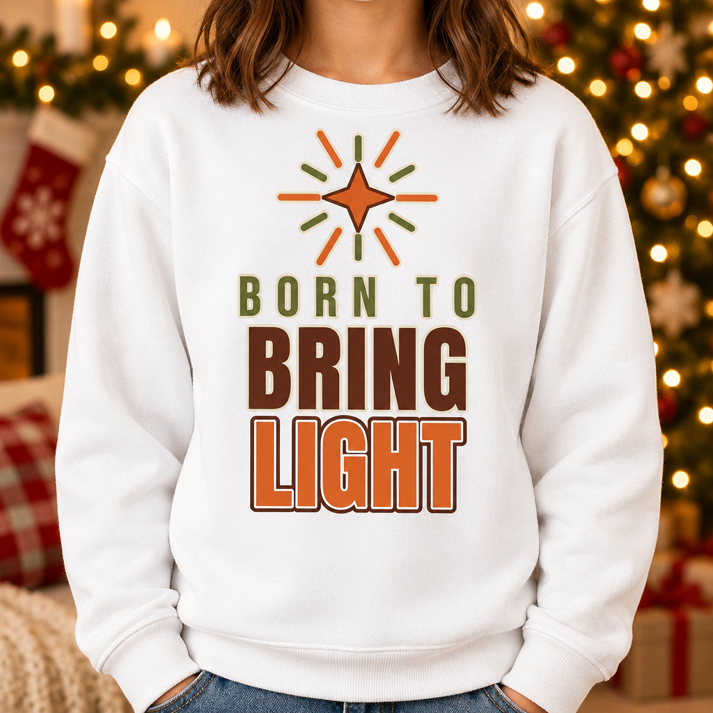 Child wearing the Modern Christian Kids Sweatshirt: Born to Bring Light Bold in a cozy Christmas living room, cropped torso view