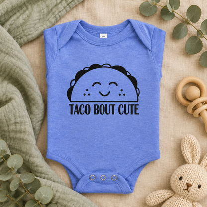 Taco 'Bout Cute Baby Bodysuit in Heather Columbia Blue, folded flat lay - Cartsy