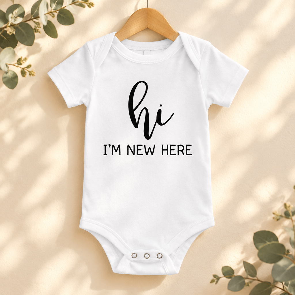 Hi I'm New Here Newborn Baby Bodysuit in White on a wooden hanger - Cartsy