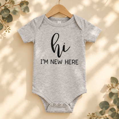 Hi I'm New Here Newborn Baby Bodysuit in Athletic Heather on a wooden hanger - Cartsy