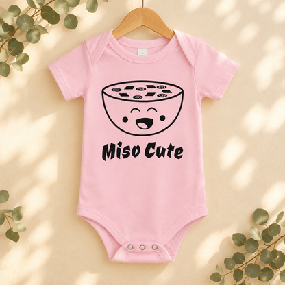 Miso Cute Baby Bodysuit in Pink on a wooden hanger - Cartsy