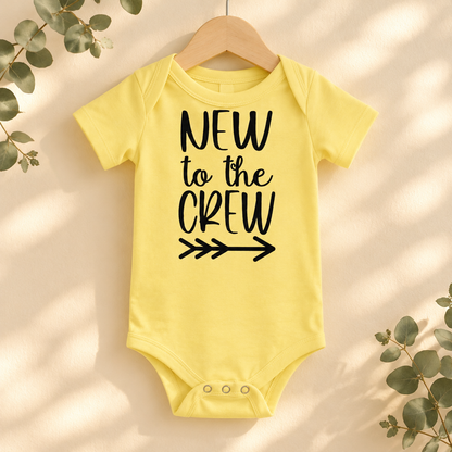 New to the Crew Baby Bodysuit in Yellow on a wooden hanger - Cartsy