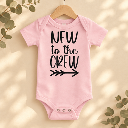 New to the Crew Baby Bodysuit in Pink on a wooden hanger - Cartsy