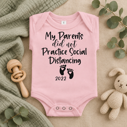 My Parents Did Not Practice Social Distancing Baby Bodysuit in Pink, folded flat lay - Cartsy