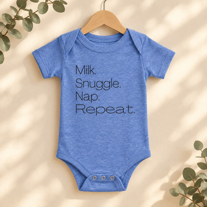 Milk Snuggle Nap Repeat Baby Bodysuit in Heather Columbia Blue on a wooden hanger - Cartsy