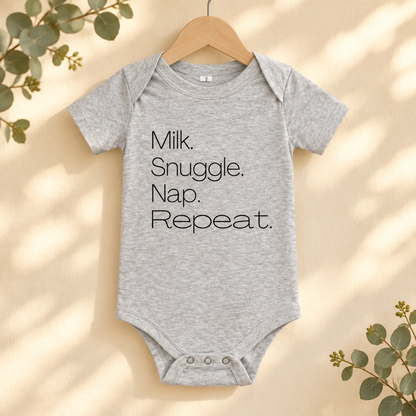 Milk Snuggle Nap Repeat Baby Bodysuit in Athletic Heather on a wooden hanger - Cartsy