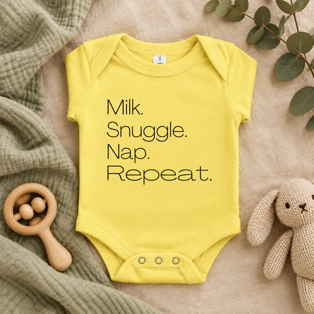 Milk Snuggle Nap Repeat Baby Bodysuit in Yellow, folded flat lay - Cartsy