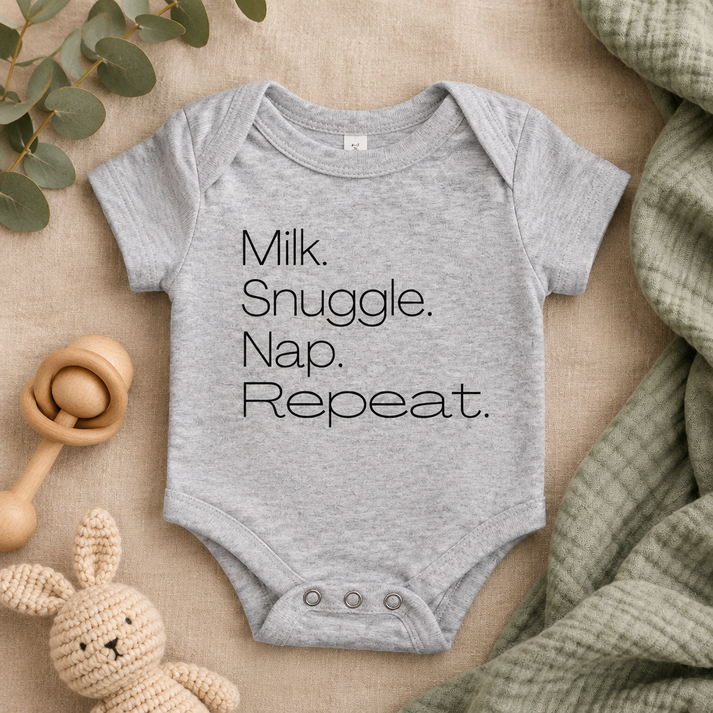 Milk Snuggle Nap Repeat Baby Bodysuit in Athletic Heather, folded flat lay - Cartsy