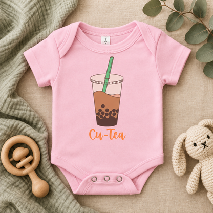 Cu-Tea Boba Tea Baby Bodysuit in Pink, folded flat lay - Cartsy
