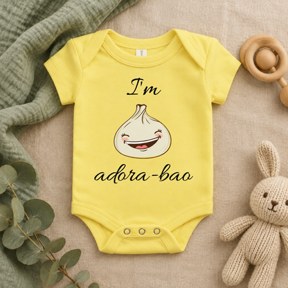 I'm Adora-Bao Dumpling Baby Bodysuit in Yellow, folded flat lay - Cartsy