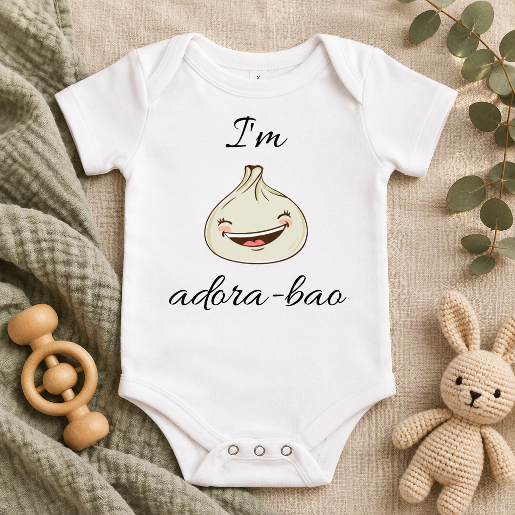 I'm Adora-Bao Dumpling Baby Bodysuit in White, folded flat lay - Cartsy