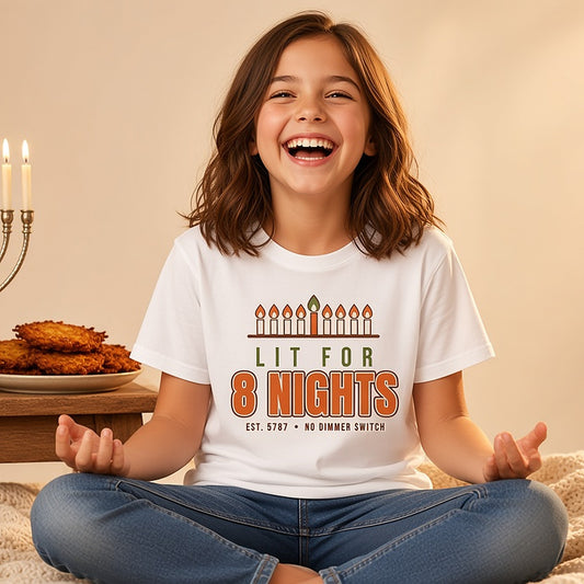 Girl laughing beside a menorah and latkes in the Lit for 8 Nights tee