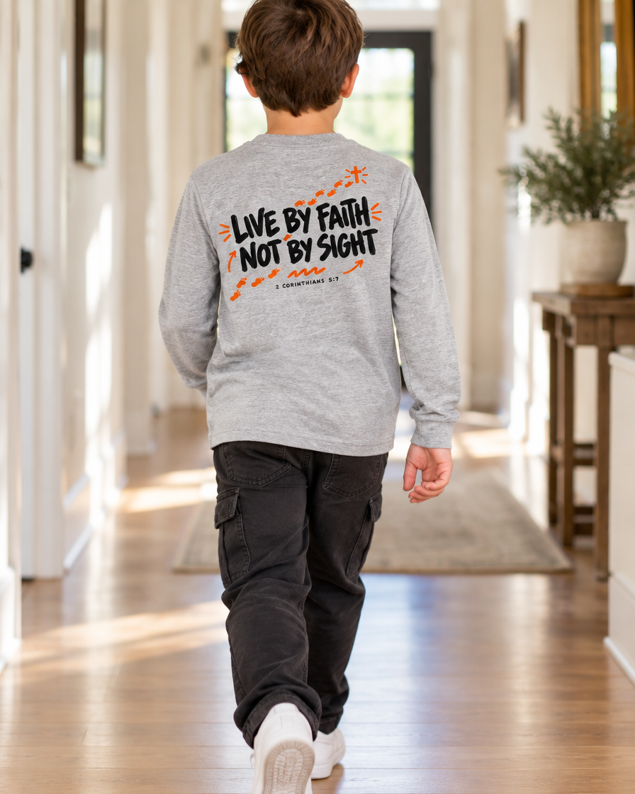 Kid wearing the Cartsy Walk By Faith long sleeve Christian tee in athletic heather