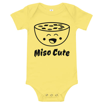 Yellow baby bodysuit with a smiling miso soup bowl and the words 'Miso Cute'